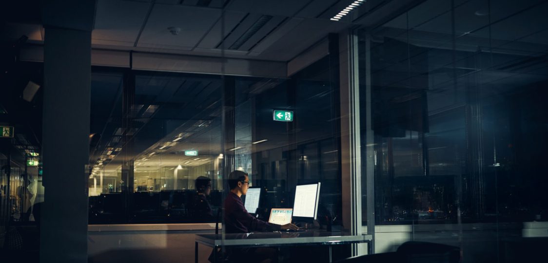 Shot of a businessman working late in an office